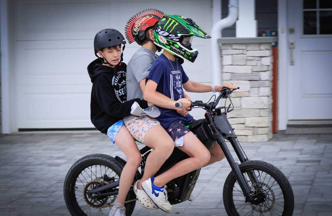 Children ride an e-bike in Point Pleasant, New Jersey, in 2025. Sales of e-bikes have surged in recent years, prompting schools, law enforcement agencies and lawmakers in California to address safety and regulatory concerns as more young riders use the devices.