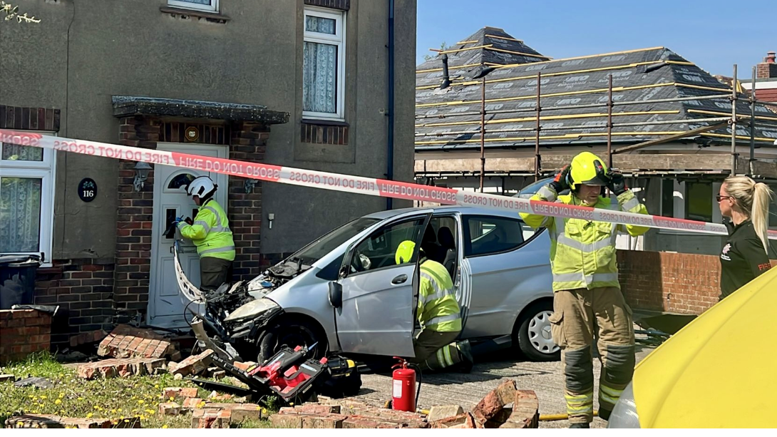 Driver taken to hospital after garden wall crash