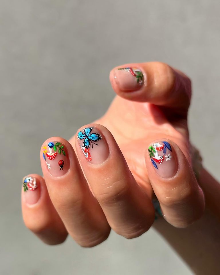 Butterfly, flower and mushroom designs at the tip of the nail