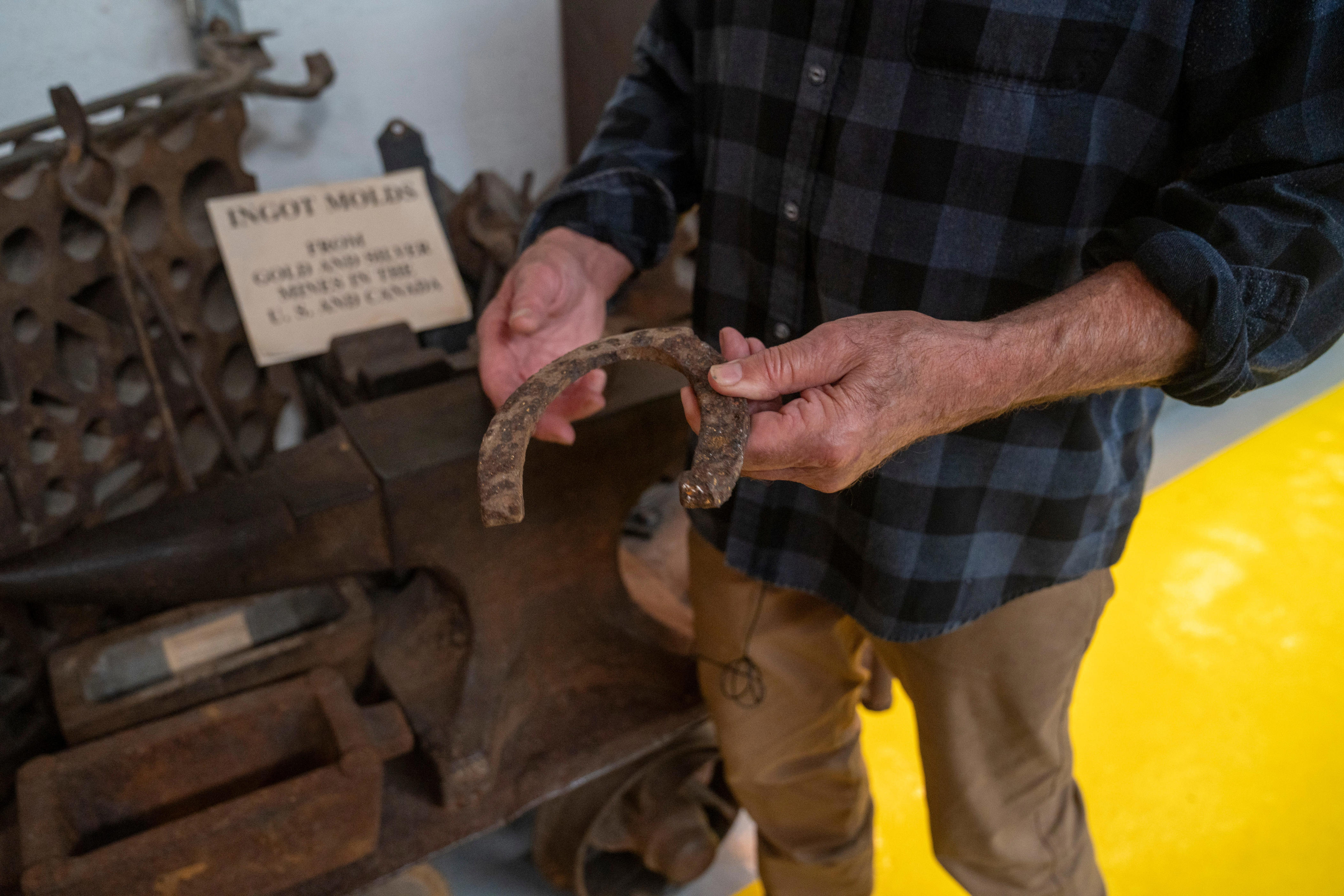 William Kroth, president and executive director, holds up a horseshoe made of iron inside the Sterling Hill Mine Museum on Tuesday, May 26, 2026, in Ogdensburg.