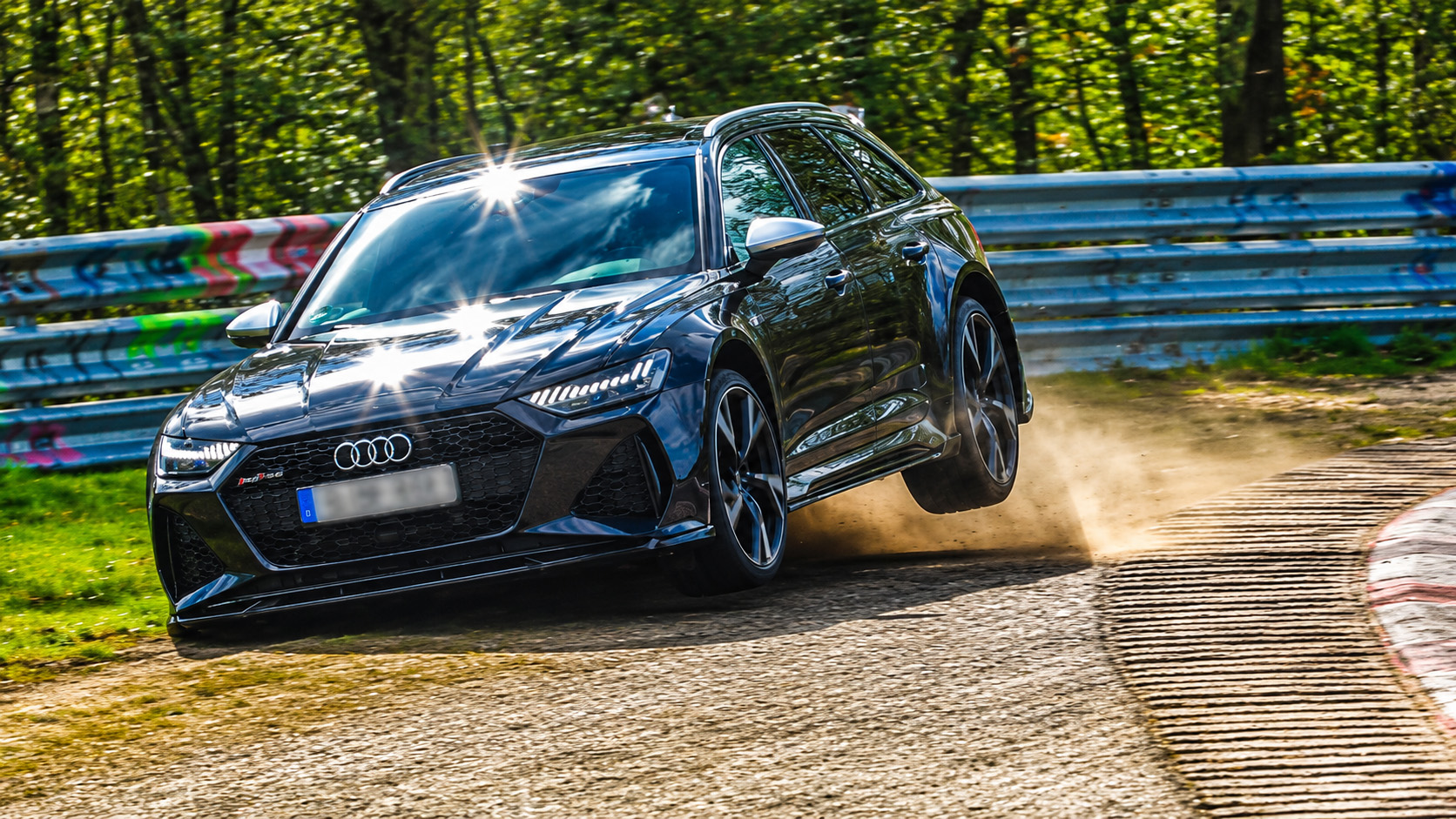 Audi RS6 nearly rolls over after one rear wheel lifts into the air