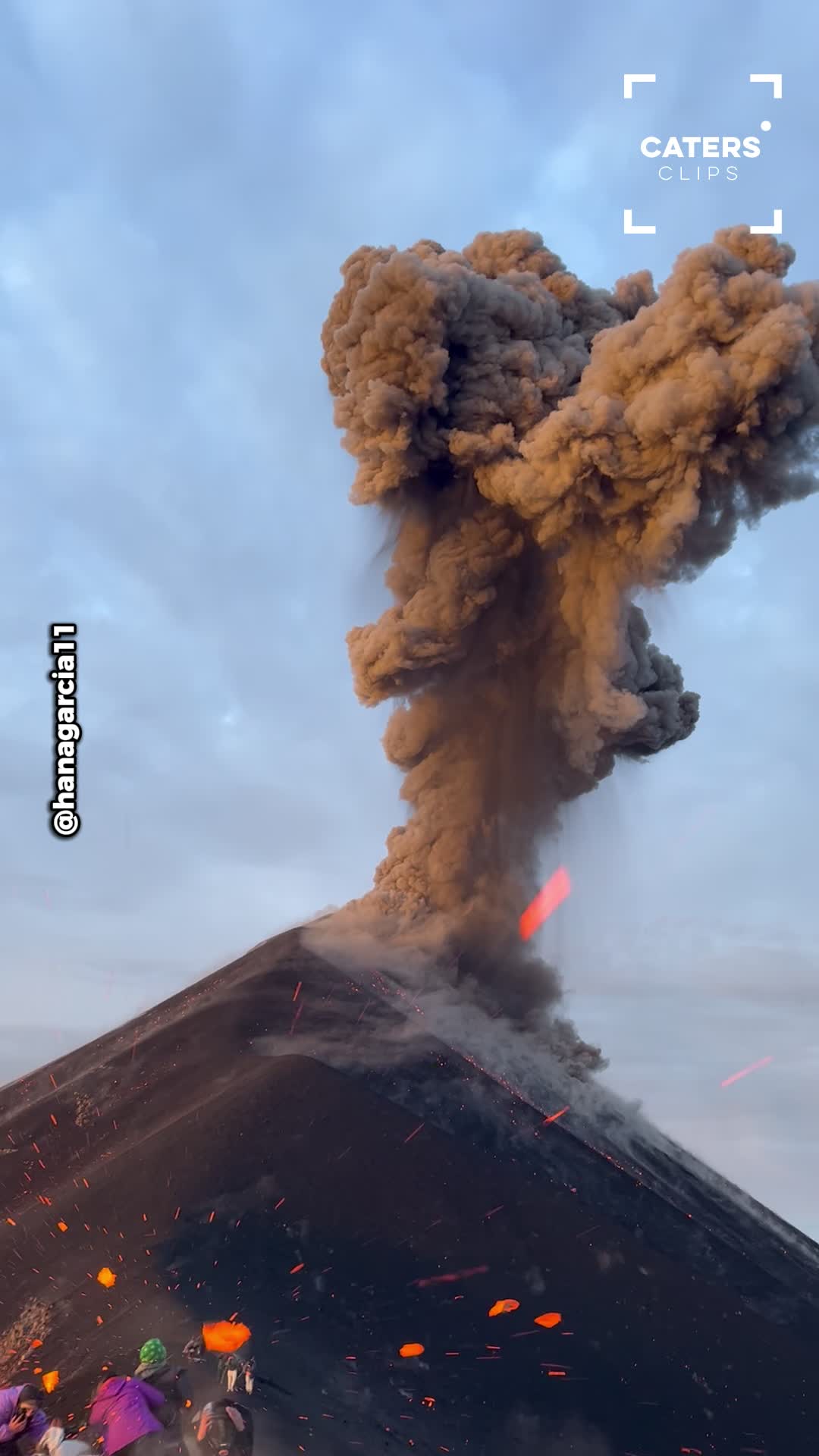 Volcano erupts and sends rock flying toward tourist