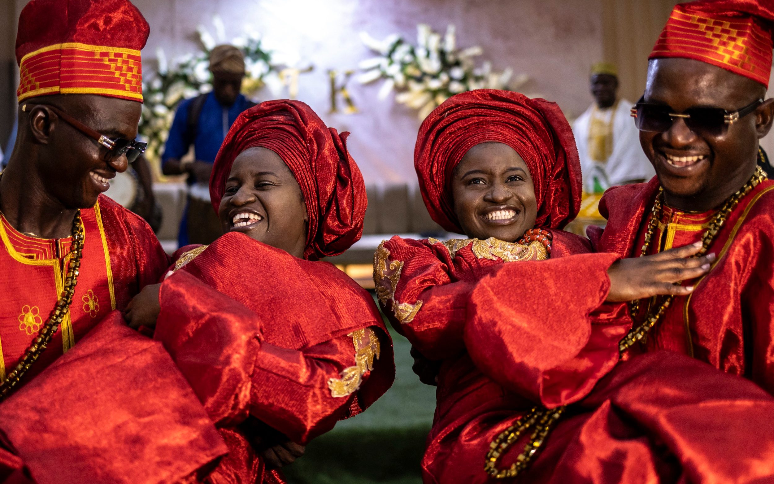 Twin brothers Kehinde and Taiwo Oguntoye carry their wives twin sisters Kehinde and Taiwo Adediran during their traditional Nigerian wedding ceremony - OLYMPIA DE MAISMONT/AFP