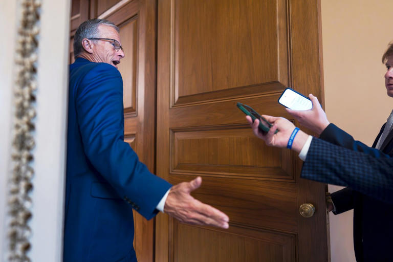 Senate Majority Leader John Thune talking with reporters Tuesday.