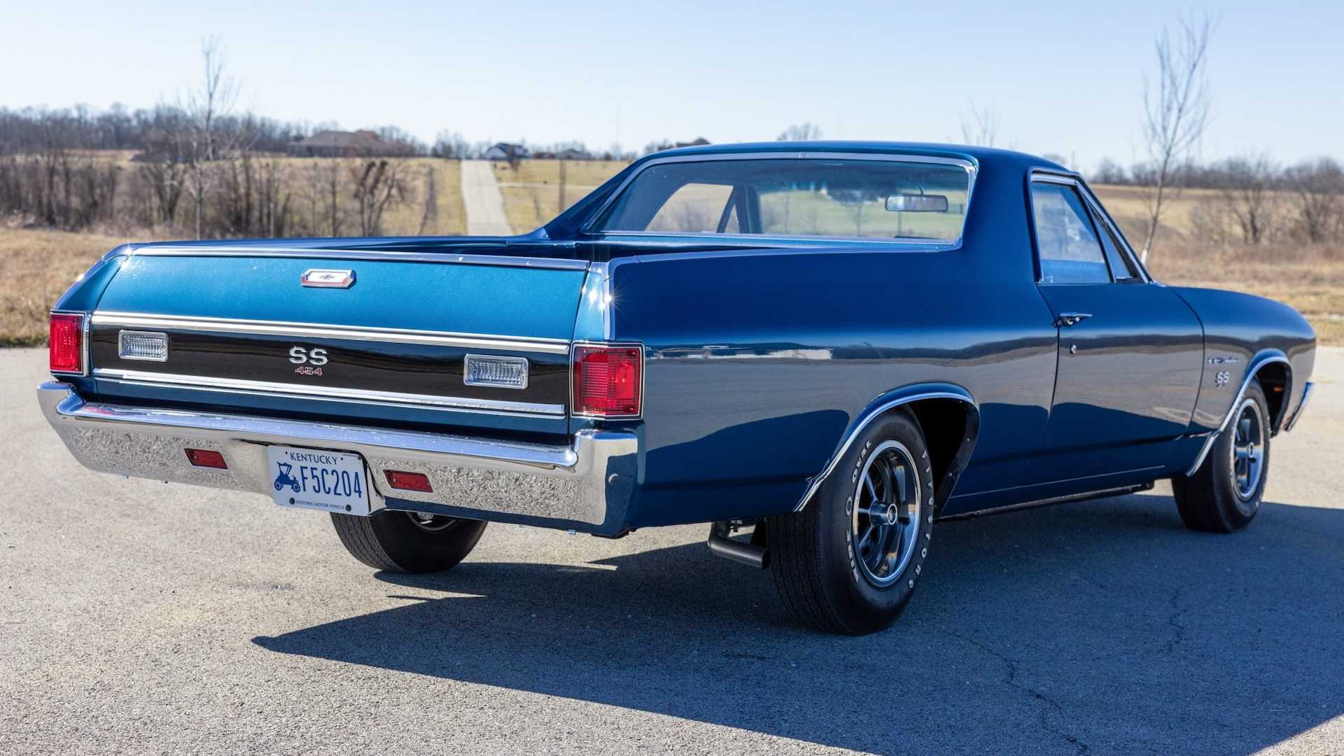 Bed and a rear end of a compact 1970s pickup truck.