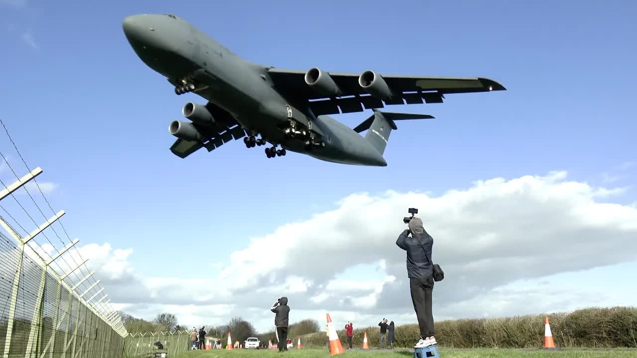Watch the C-5M Super Galaxy crawl in - then the runway gets swallowed