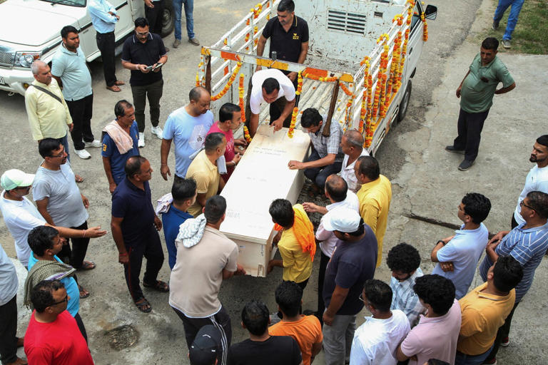 Mourners at the home of Aditya Sharma, an Indian seafarer aboard the Palau-flagged tanker MT Settebello who was among three crew members killed in a U.S. attack on the tanker, in Hamirpur