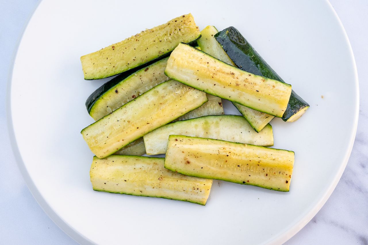 Plate with roasted zucchini spears arranged in a pile