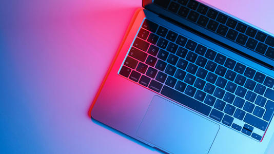 a laptop in blue and pink light