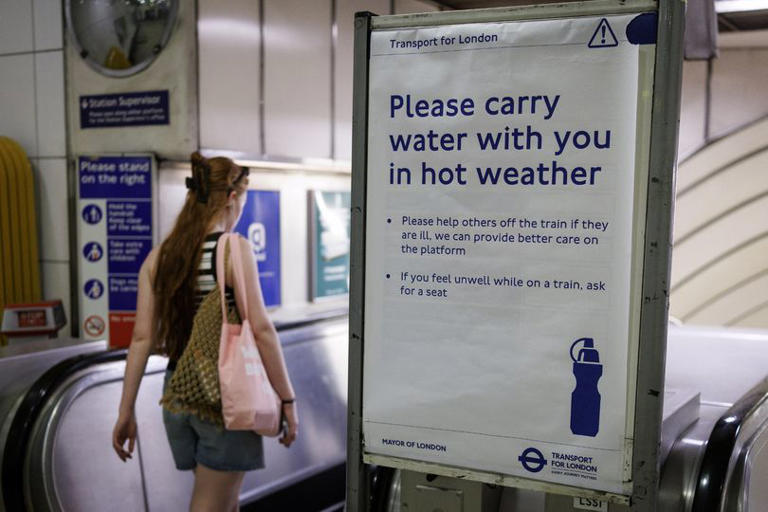 Mandatory Credit: Photo by TOLGA AKMEN/EPA/Shutterstock (16957624b) A person goes past a sign warning passengers of the hot weather on the London Underground as the UK is set to experience its hottest June day on record during a heatwave in London, Britain, 24 June 2026. The Met Office has issued its second ever red warning for extreme heat, as temperatures are expected to reach at least 39 Celsius, with some areas potentially reaching close to the UK's all-time high with 40 degrees Celsius. UK Met Office issues red extreme heat warning for southern England, London, United Kingdom - 24 Jun 2026