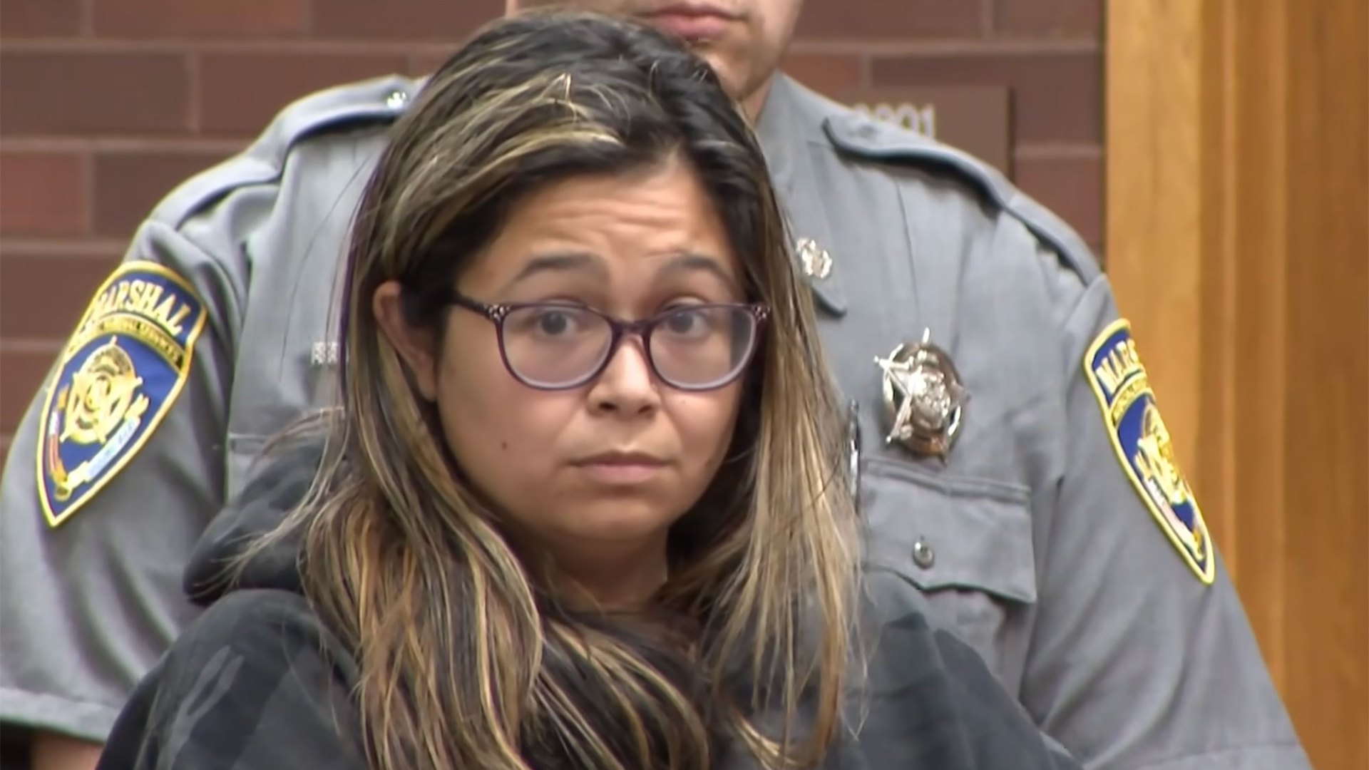 Woman charged with murder 8 years after leaving newborn son in dumpster