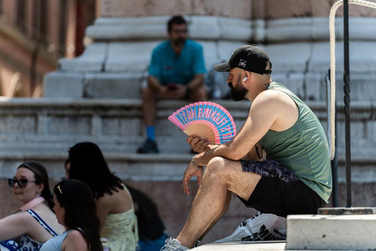 A person seeks relief from high temperatures during a heatwave in Bologna yesterday (file photo)
