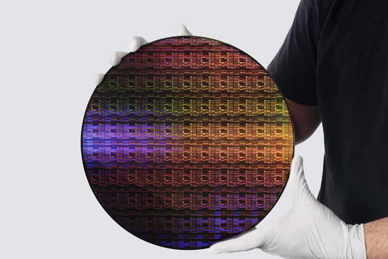 A researcher holds IBM's sub-1 nanometer node wafer.