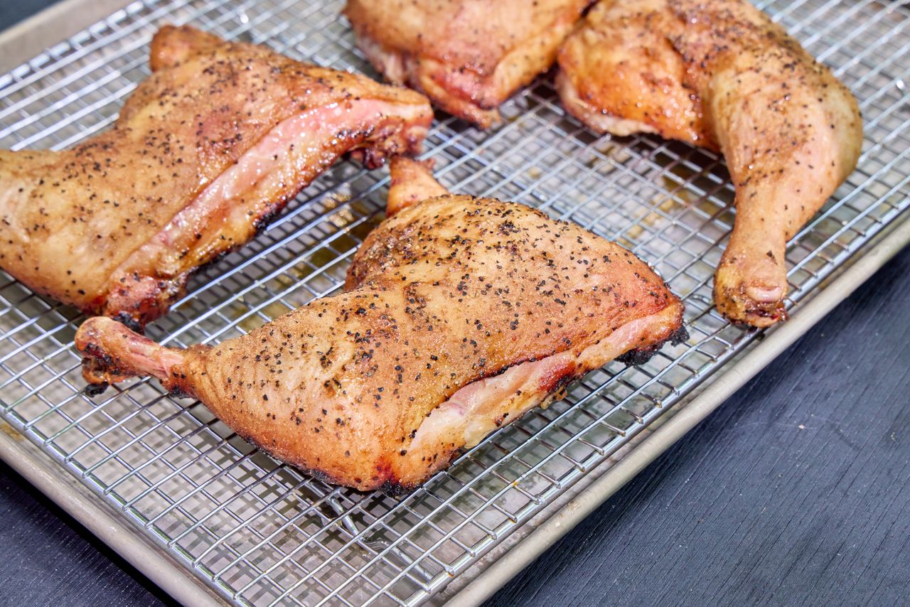 Chicken cooked in the Masterbuilt Gravity Series 1150 Digital Charcoal Grill and Smoker on a metal tray