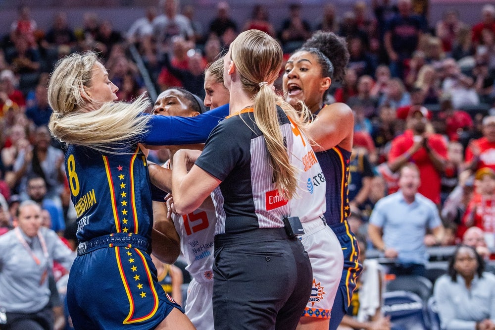 Jun 17, 2025; Indianapolis, Indiana, USA; Indiana Fever guard Sophie Cunningham (8) and Connecticut Sun guard Jacy Sheldon (4) get into a fight in the second half at Gainbridge Fieldhouse. Mandatory Credit: Trevor Ruszkowski-Imagn Images