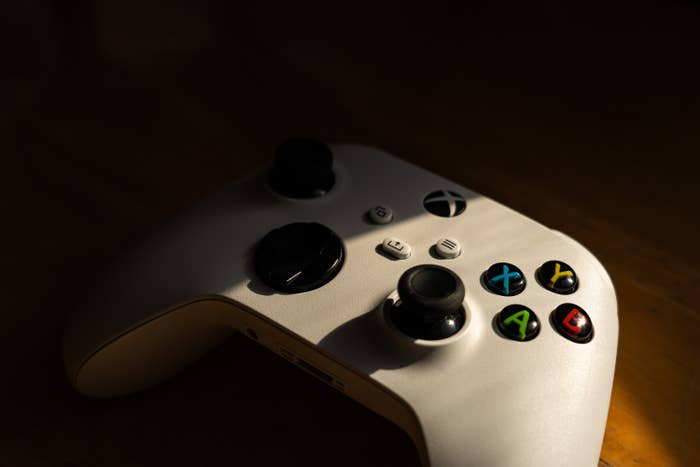 Video game controller resting on a surface, buttons illuminated, suggesting a focus on gaming and family-friendly entertainment