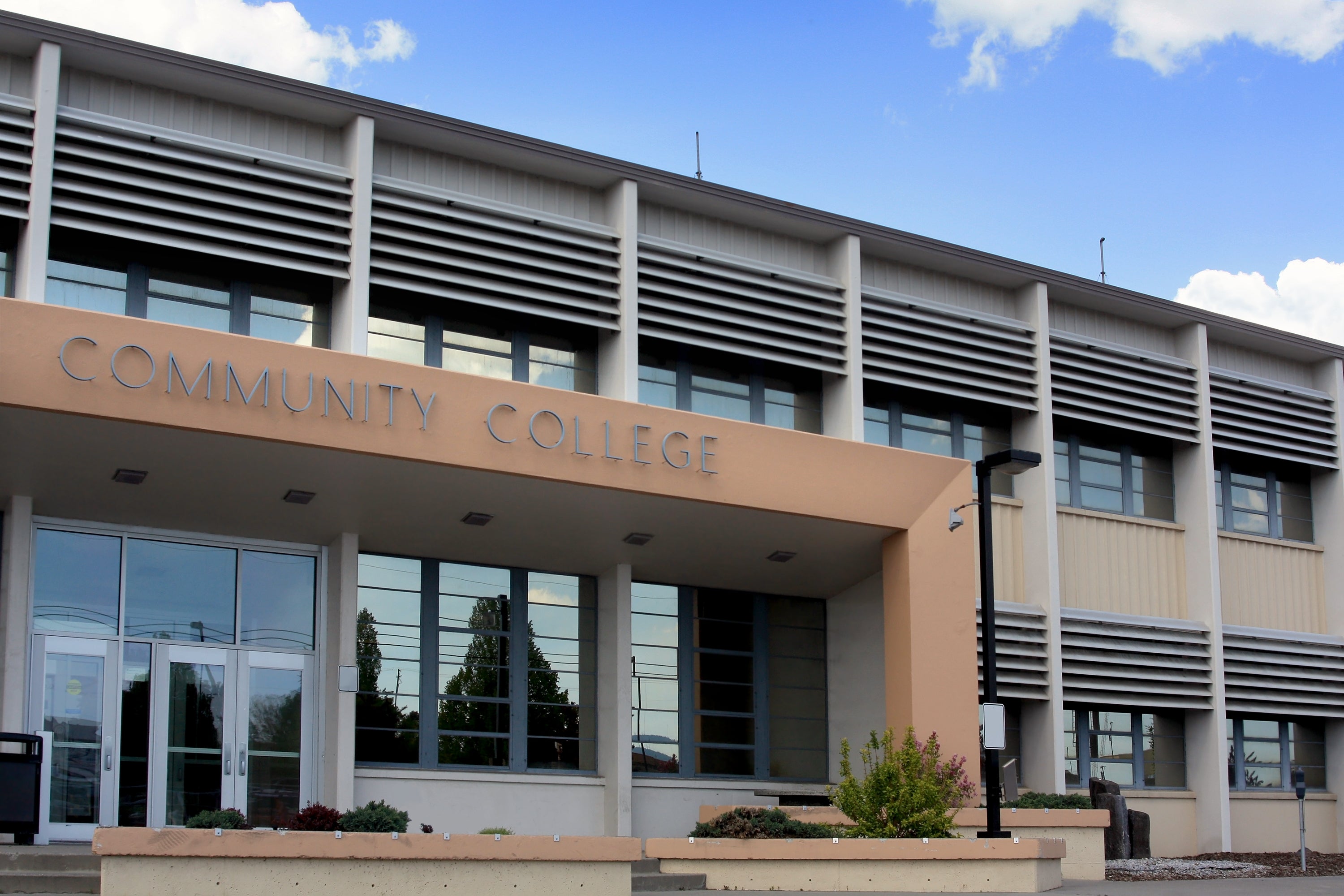 Community college building with a modern facade and large windows under a clear sky