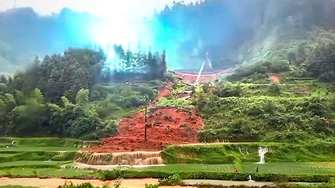 Landslide sweeps through rice fields and topples live power lines in ...