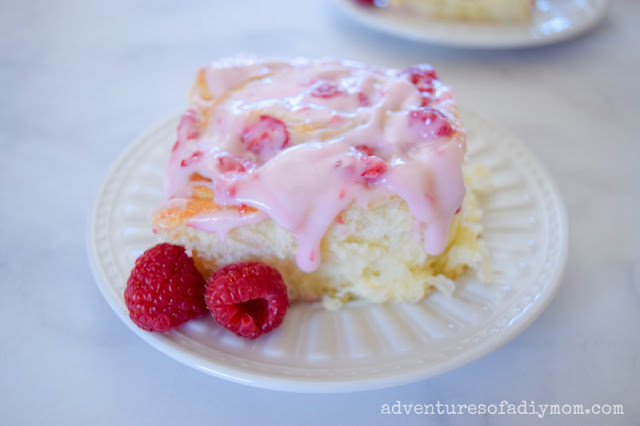 raspberry roll with raspberry cream cheese frosting in a plate