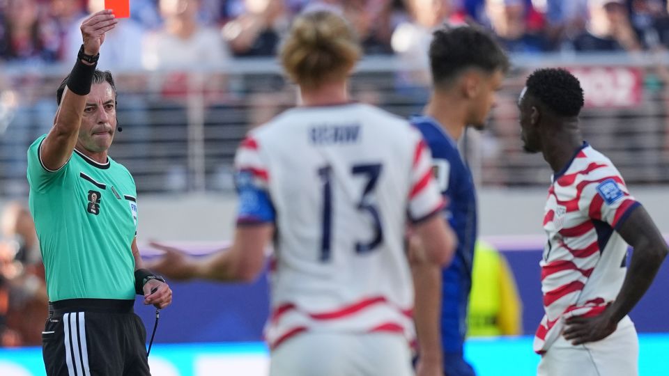 Referee Raphael Claus shows a red card to Balogun after a VAR review. - Julio Cortez/AP