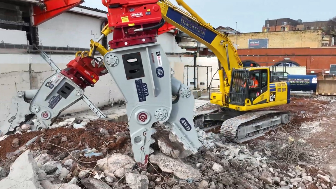 Massive demolition machines tearing down concrete structures with ease