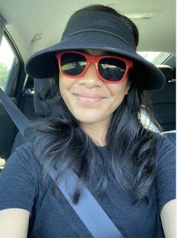 Reviewer in wide brimmed black visor