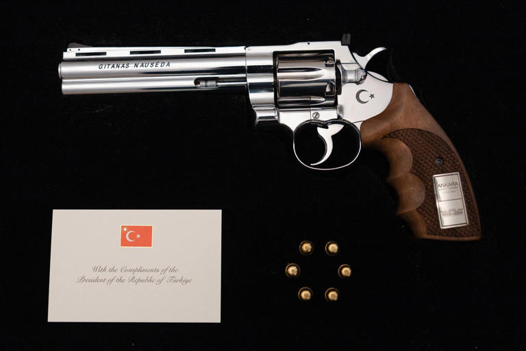 A revolver given to Lithuanian President Gitanas Nauseda, with the president's name engraved on it, is displayed during a press presentation in Vilnius, Lithuania. Photo: Office of the Lithuanian President via AFP