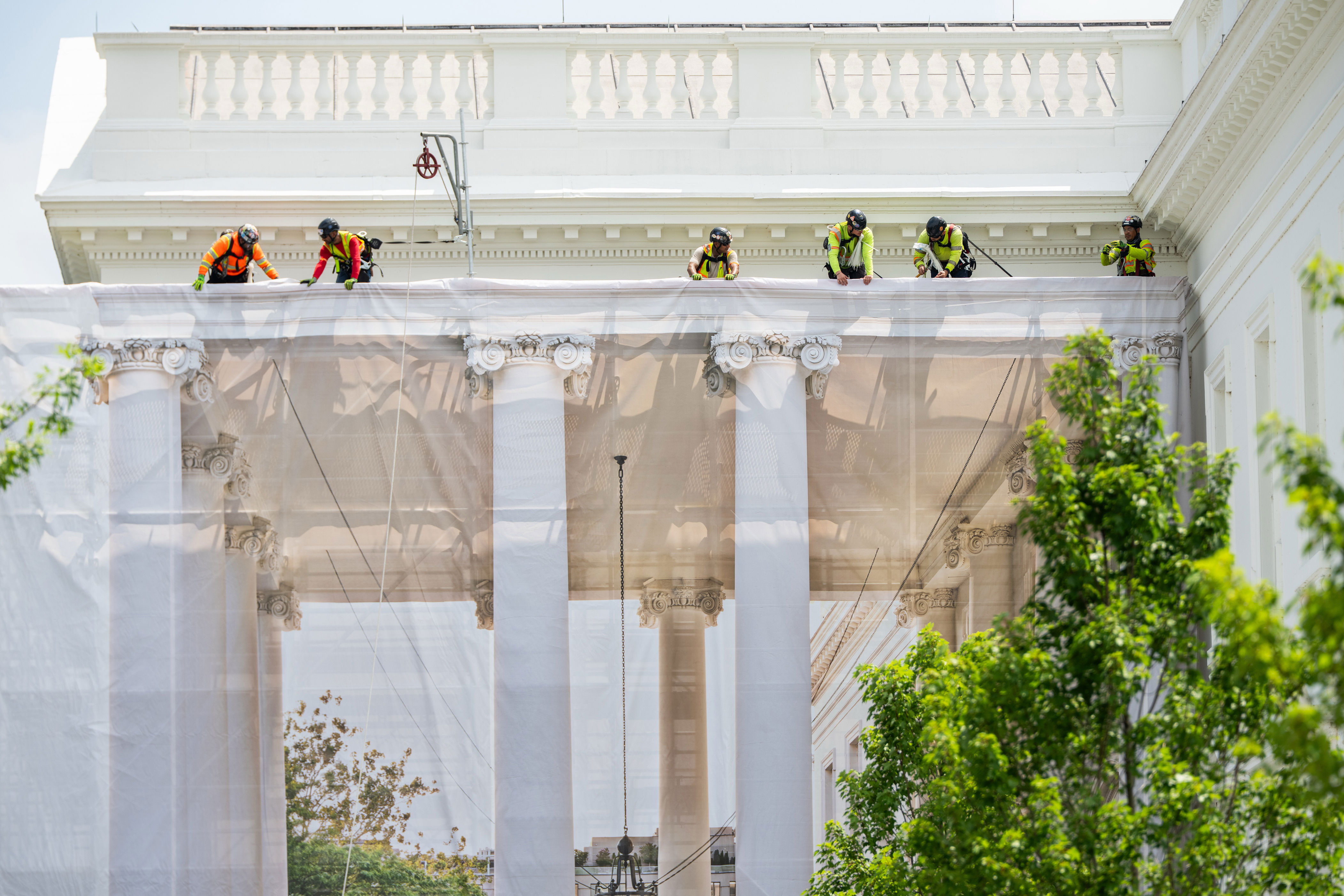 Giant printed tarps are now hanging off the White House