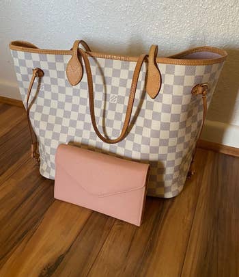 The pink wallet next to a bag