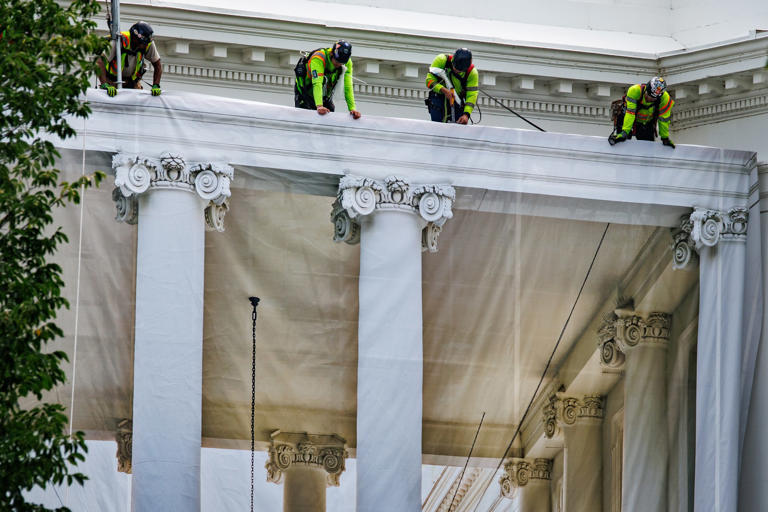 Trump posts photo of ornate columns as tarps cover White House portico