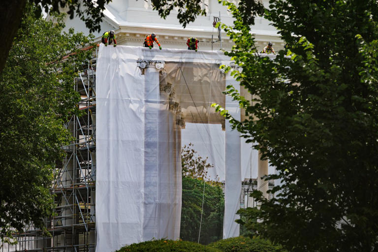 Trump posts photo of ornate columns as tarps cover White House portico