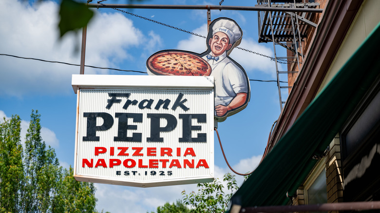 A sign for Frank Pepe pizzeria hanging above the building in New Haven, Connecticut.