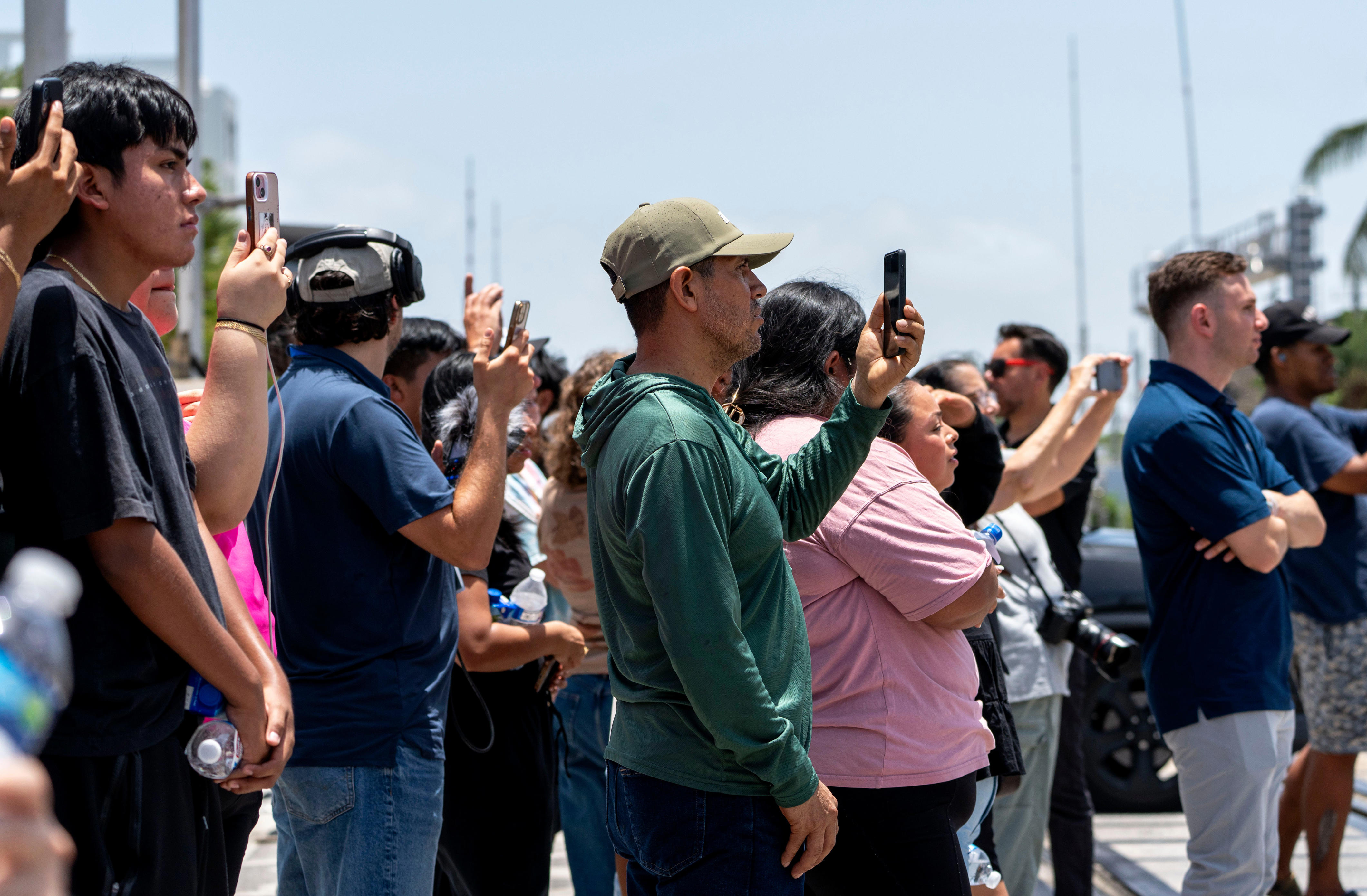 People watch and photograph ICE agents and FHP troopers at the El Quetzal Panaderia Y Cafeteria on July 9, 2026 in Lake Worth Beach, Florida. Neither agency commented on why he was arrested.
