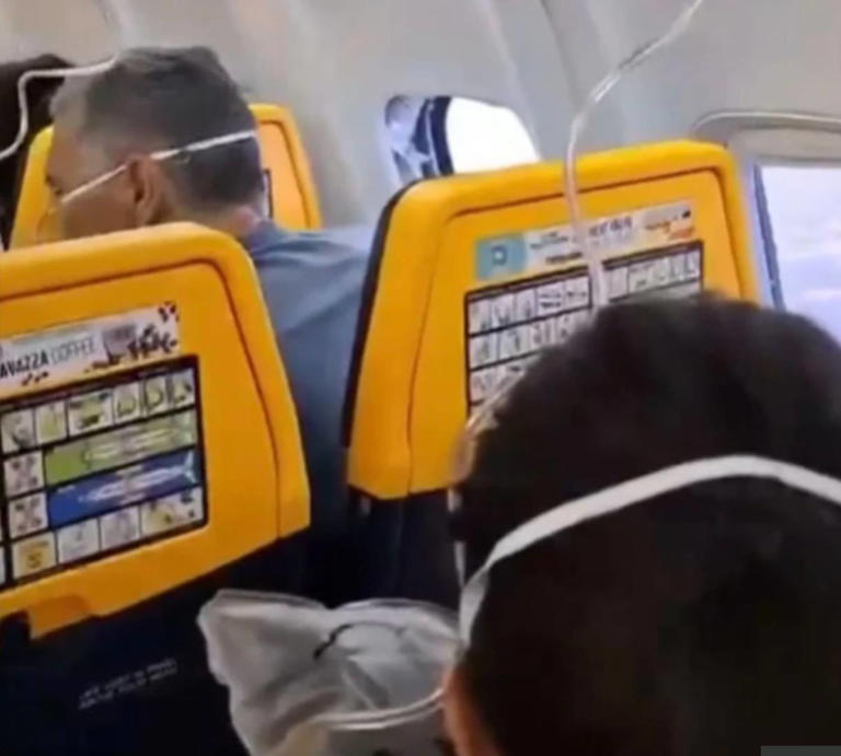 Ryanair passenger saved from being sucked out of plane after window ...