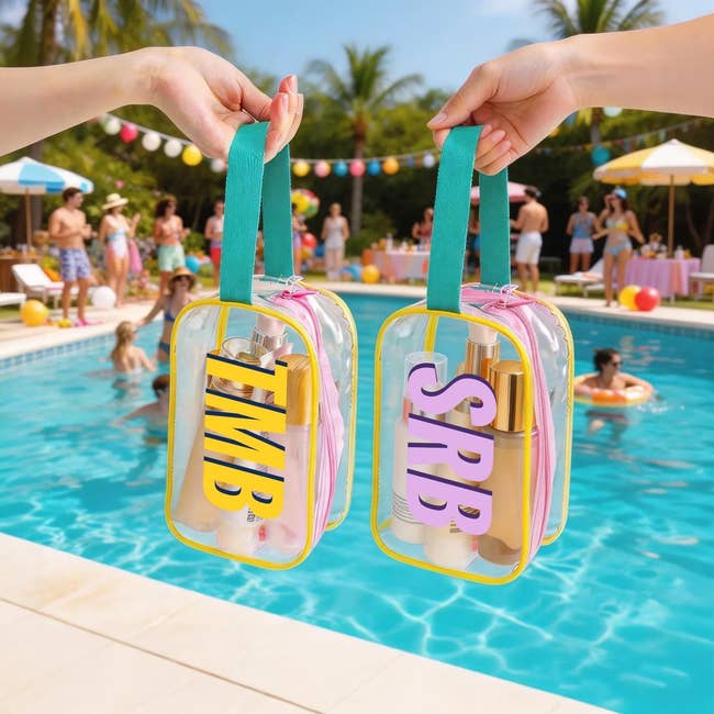 Two hands holding clear toiletry bags with skincare products near a poolside party, featuring people in swimwear and tropical decor in the background