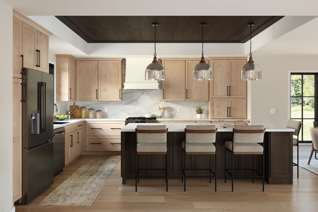 A modern kitchen with lightcolored cabinets a black countertop island and pendant lighting showcasing contemporary design trends