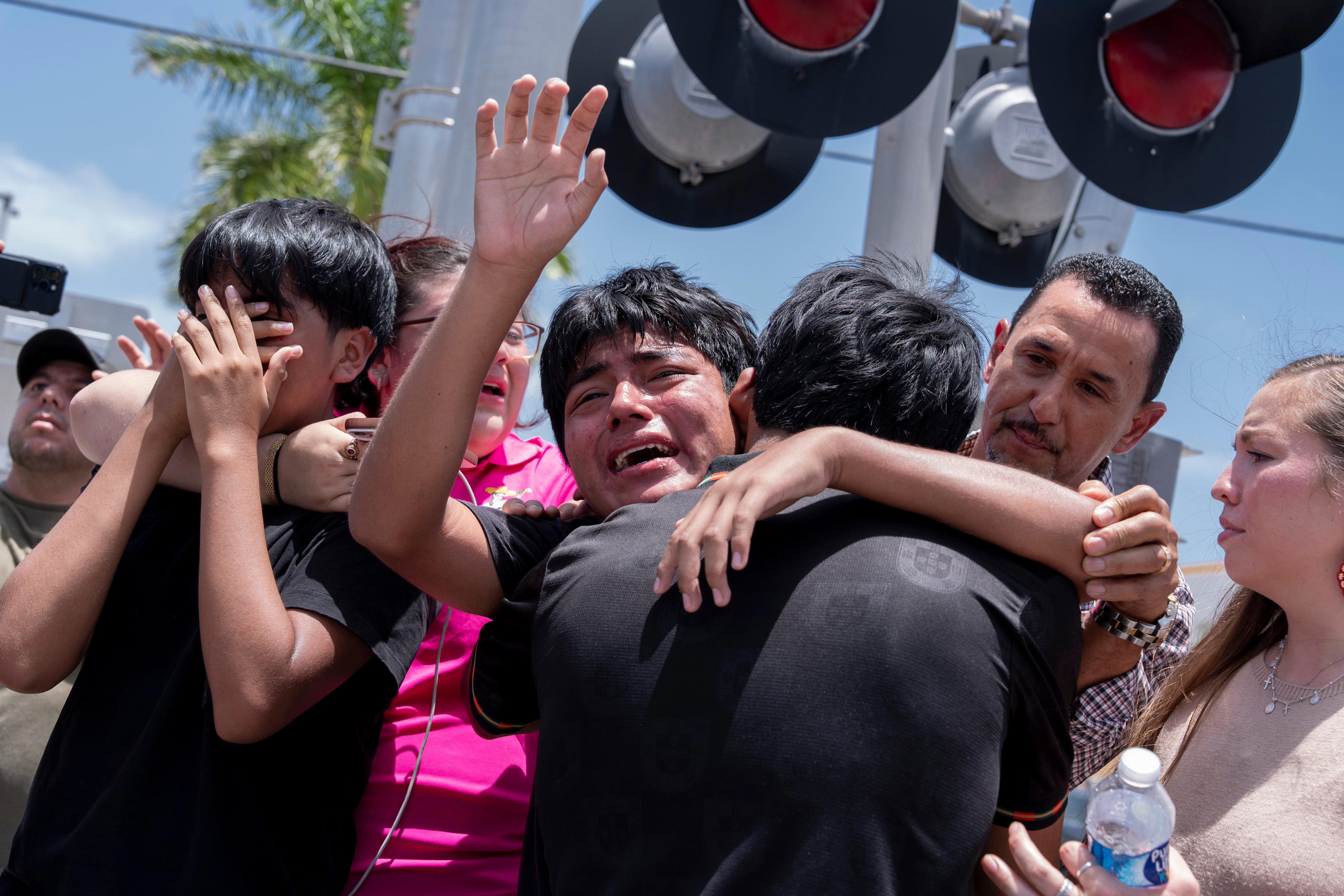 A boy cries with his family after ICE agents and FHP troopers arrested his father at the El Quetzal bakery on July 9, 2026 in Lake Worth Beach, Florida.