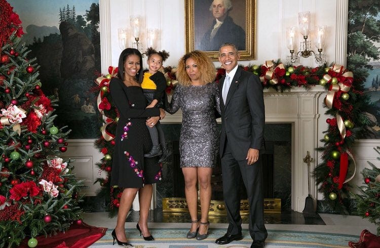 The author (third from left) with her daughter and former President Barack Obama and former first lady Michelle Obama at an event at the White House during the holiday season.