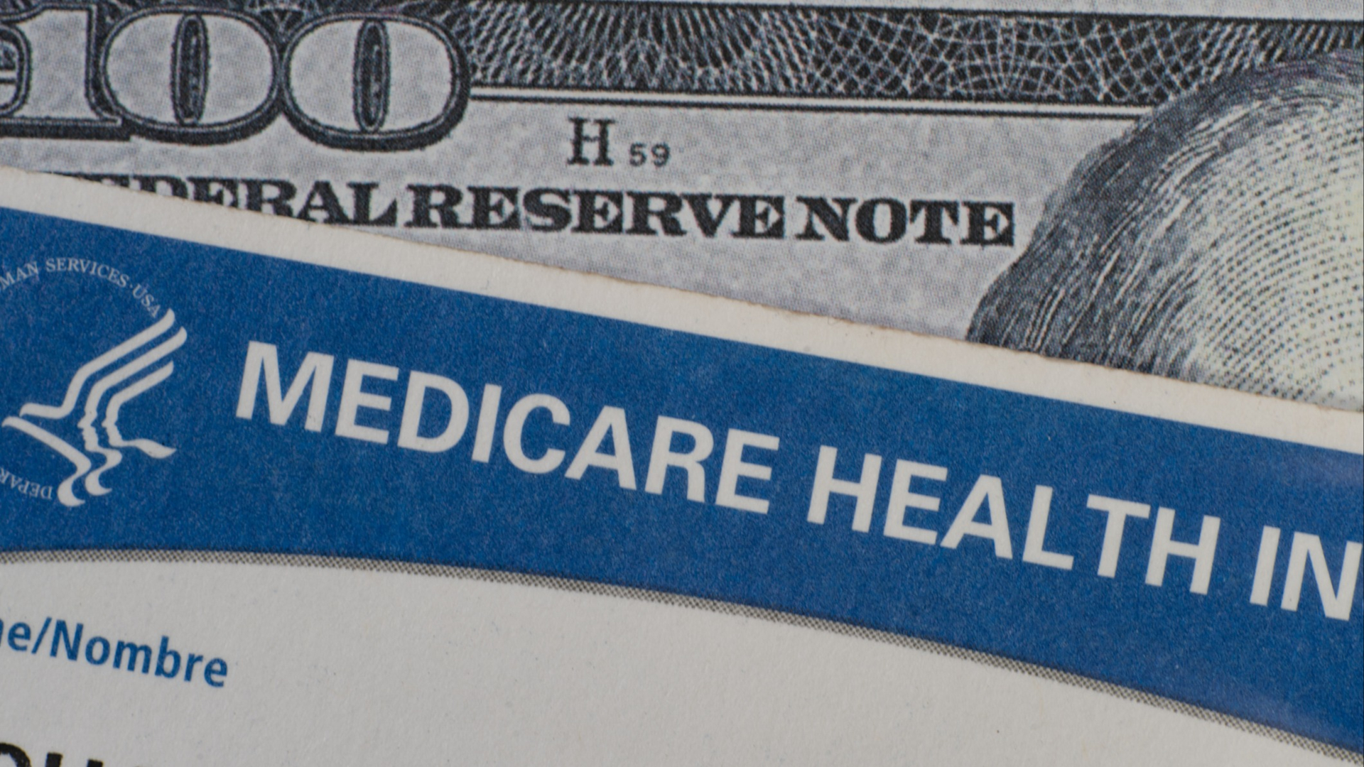 Discover A close up of Medicare card on 100 USD dollar bill showing the top of Ben Franklin's head