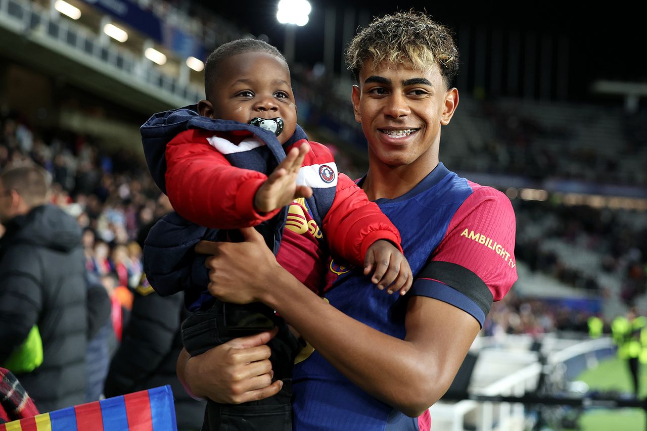 Lamine Yamal of FC Barcelona celebrates victory while holding his brother