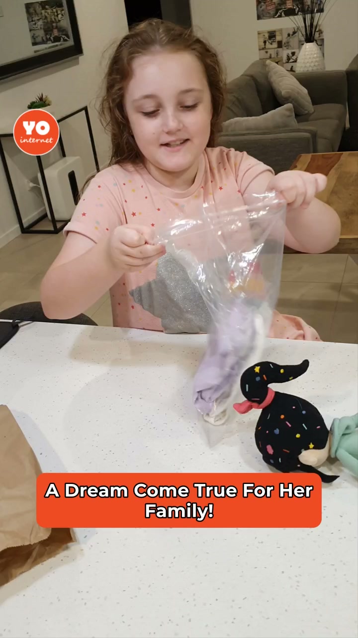 Young girl joyfully embraces her new twin siblings