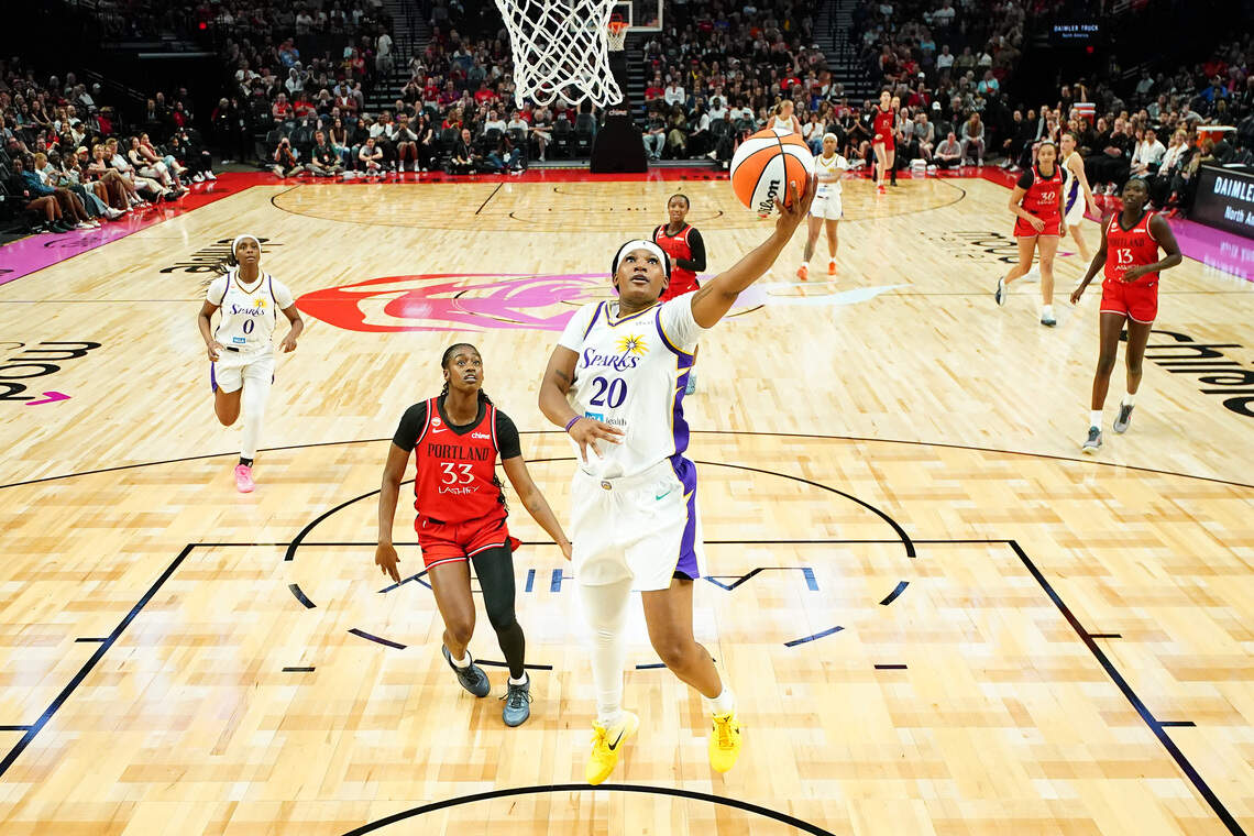 Sania Feagin #20 of the Los Angeles Sparks drives to the basket against Maya Caldwell #33 of the Portland Fire during the second half of a preseason game at Moda Center on May 03, 2026 in Portland, Oregon.