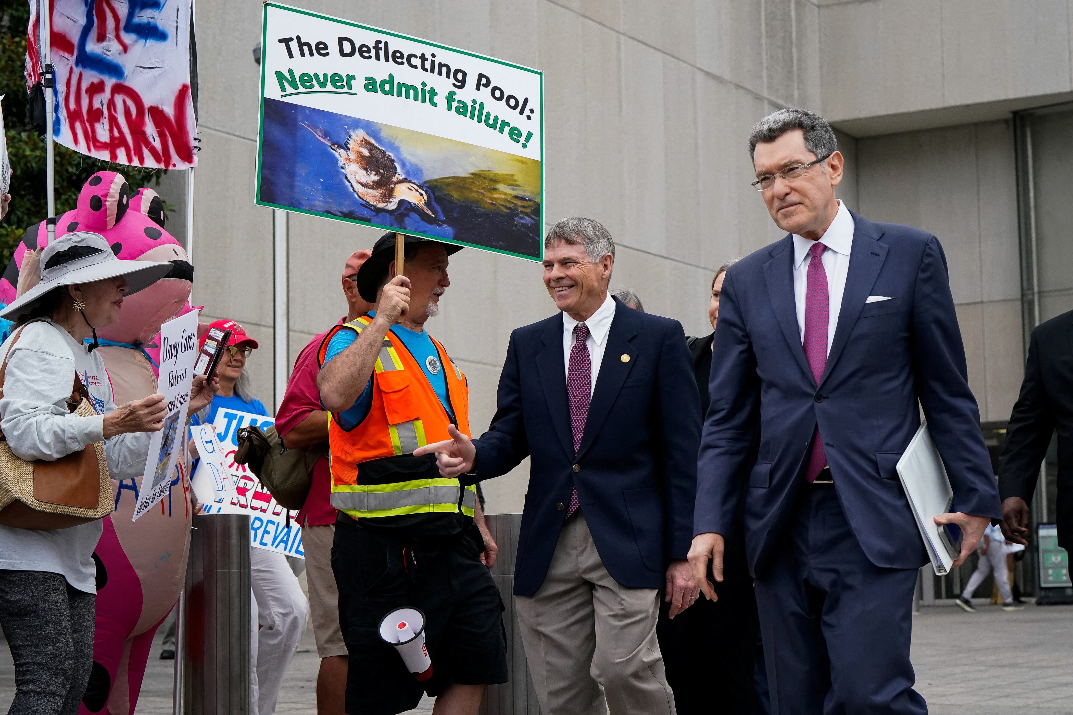 Former U.S. Olympic canoeist David Hearn gestures while walking with his attorney Norm Eisen following Hearn’s arraignment on a felony destruction of property charge related to “vandalizing” the Lincoln Memorial Reflecting Pool, at DC Superior Court in Washington, D.C., U.S., July 9, 2026. REUTERS/Elizabeth Frantz / Elizabeth Frantz / REUTERS