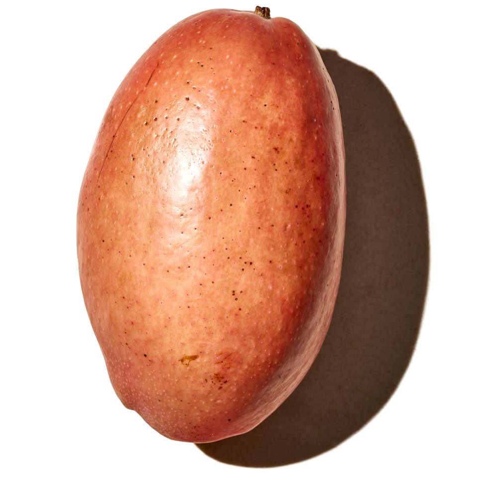 A mango on a plain background