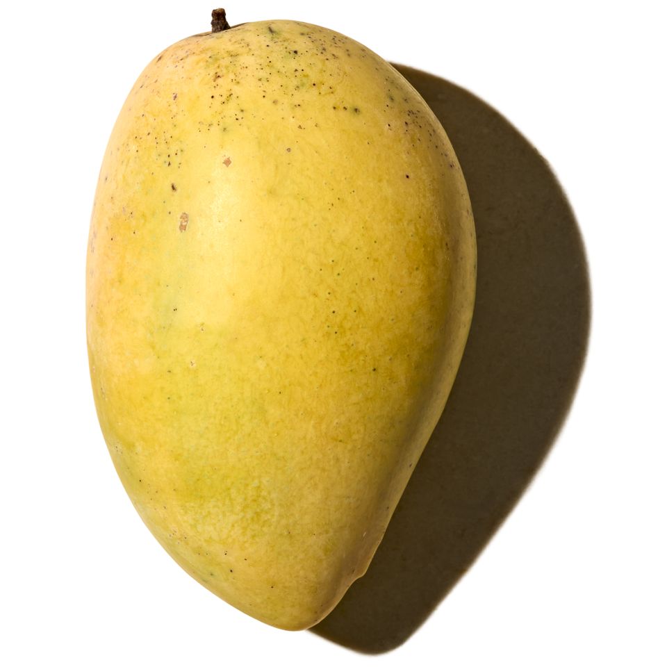 A mango with a shadow on a white background