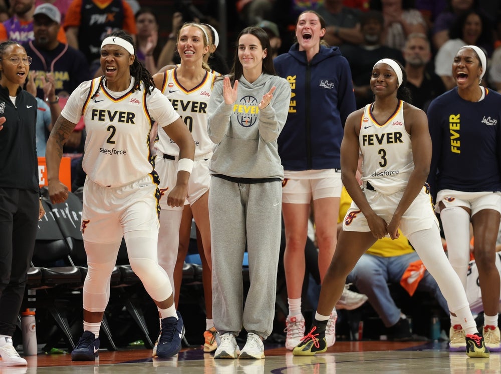 Jul 9, 2026; Phoenix, Arizona, USA; Indiana Fever guard Caitlin Clark (center) celebrates with forward Myisha Hines-Allen (2) and guard Raven Johnson (3) against the Phoenix Mercury at Mortgage Matchup Center. Mandatory Credit: Mark J. Rebilas-Imagn Images