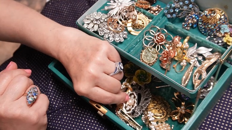 Transform old picture frames into elegant wall art with thrifted brooches