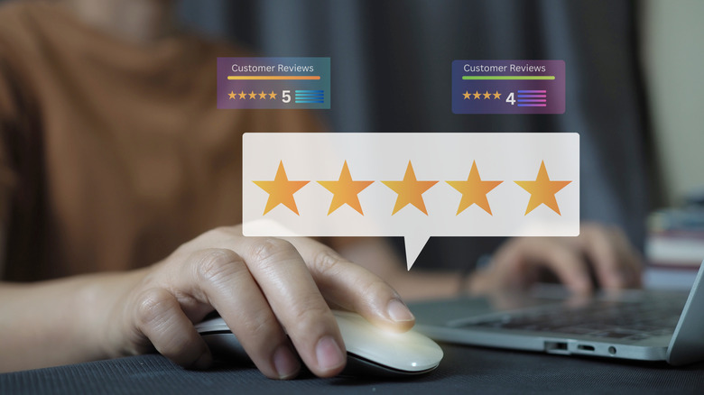 Holographic boxes of five stars and customer reviews on top of an image of a mouse and laptop.