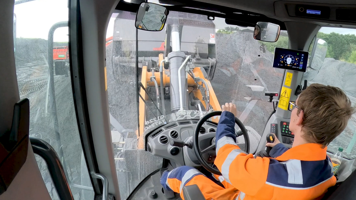 Inside the wheel loader cabin during aggregate loading operations