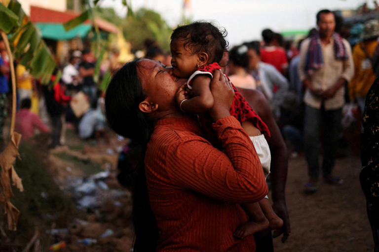 A woman kisses her baby in Banteay Meanchey province, Cambodia, last year. Commercial surrogacy is illegal in Cambodia, Thailand and Laos. Photo: Reuters
